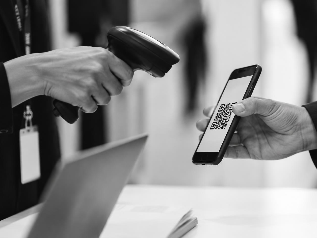QR code being scanned at an event check-in desk
